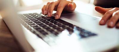 woman typing a laptop computer