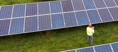 Employee inspecting solar panels