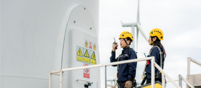 Employees performing a wind turbine inspection