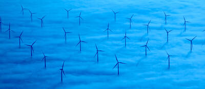 A wind farm in a sea of blue clouds