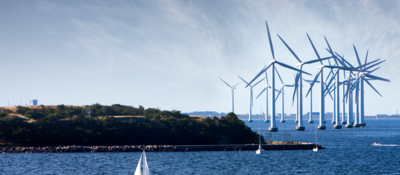 Wind turbines at sea with boat