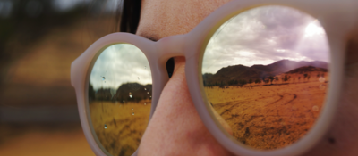 Woman with sunglasses looking at mountains