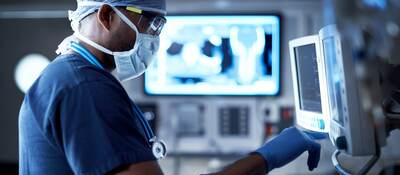 Surgeon looking at a monitor in an operating room