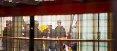 Employees discussing while standing in testing facility