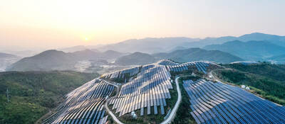 Aerial view of a solar power plant on top of a mountain.