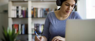 Woman in headset taking an e-learning course