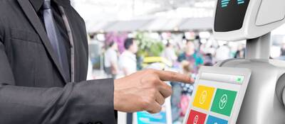 Businessman using autonomous personal assistant robot for navigation at the airport