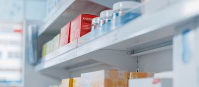 Pharmacy shelf with health and wellness products.