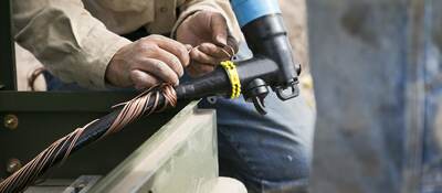 Worker installing medium voltage cable.