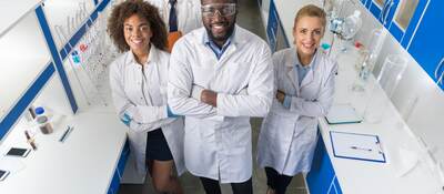 African American Scientist With Group Of Researchers In Modern Laboratory Happy Smiling, Mix Race Team Of Scientific Researchers In Lab.