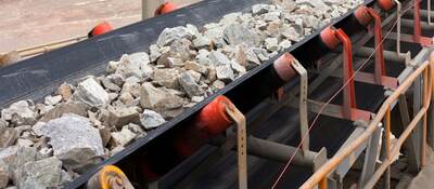 Raw material on conveyor belt before being crushed at copper mine in northern Chile.