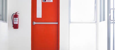 Red emergency fire door with labels