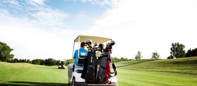 Person driving a golf cart