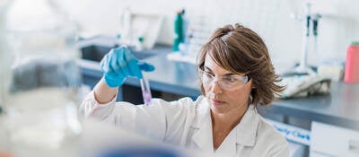 Scientist inspecting sample in a test tube