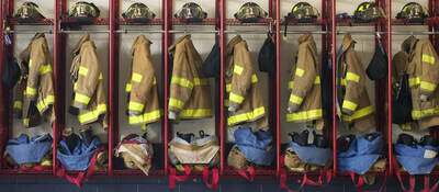 Firefighter suits hung in a row