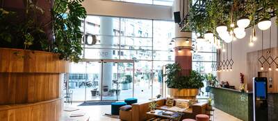 Interior of modern hotel lobby with lots of green plants