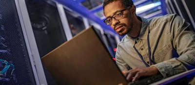IT engineer using a computer in the server room