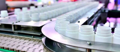 White plastic bottles on a production line