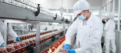 Person working with food on a production line