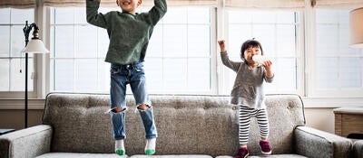 kids jumping on couch at home