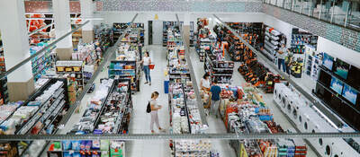Overhead view of many people shopping in a large supermarket