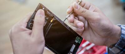 Man repairing a mobile phone.