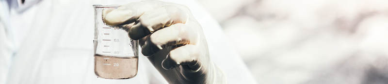 Close-up of person testing water sample.