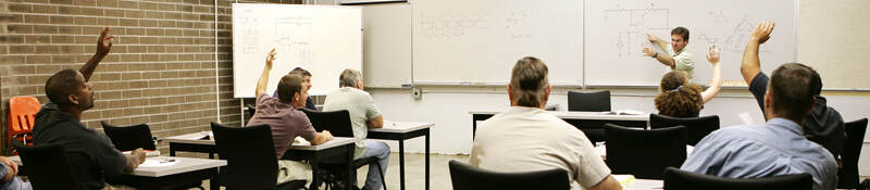 A classroom of individuals learns more about hazardous location training. 