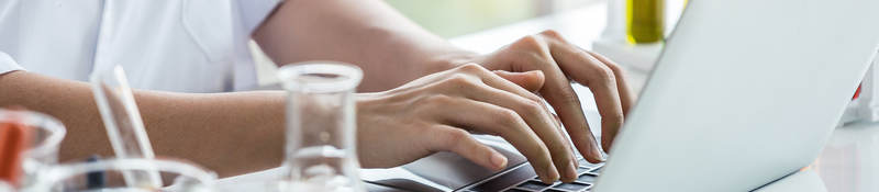 Person working on laptop at lab bench