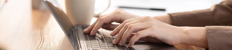 woman typing on a laptop keyboard