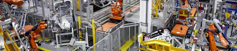 Robots putting cars together in a factory