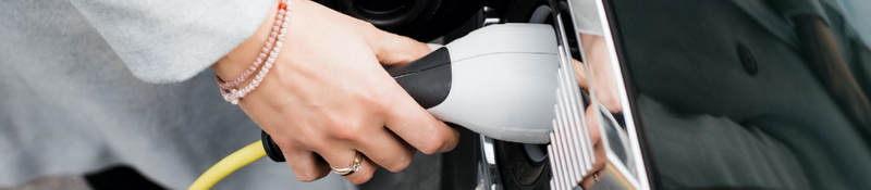 Closeup of a plug charging an electric car