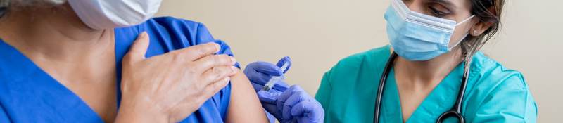 Nurse provides vaccine to elderly woman