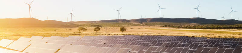 Sunrise on a solar and wind farm