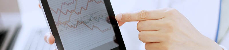 Person pointing to graph on a tablet