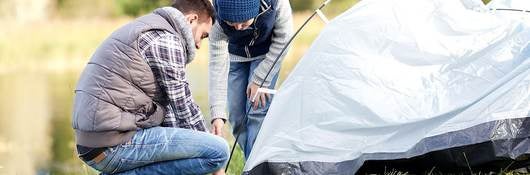 Couple setting up tent for a camping adventure