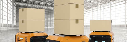 Yellow AGVs move boxes around warehouse