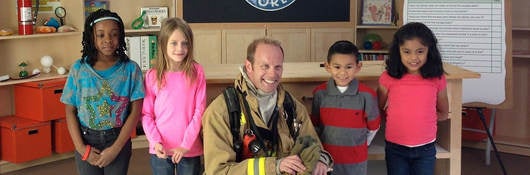 fireman and children in front of safety smart logo