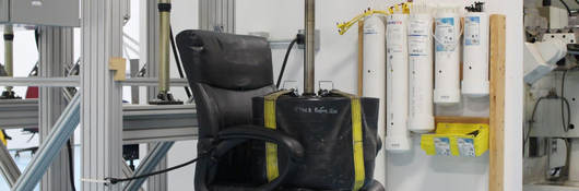 A weight sits on an office chair as part of testing