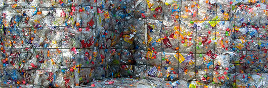 Cubes of crushed plastic bottles waiting for recycling