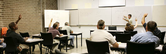 A classroom of individuals learns more about hazardous location training. 