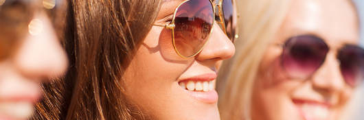 Three women wearing sunglasses