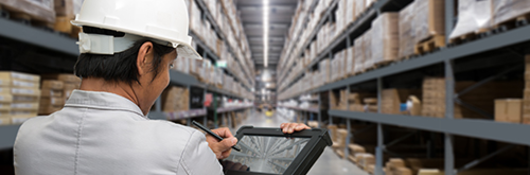 Man in hardhat w/ipad in warehouse w/H-frame
