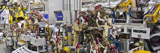 Robotic machines in a factory setting. 