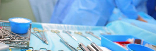 Sterile surgical equipment laid out on a tray in an operating room 