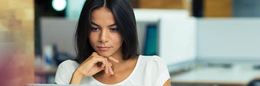 Woman sitting at her desk creating a compliant SDS. 