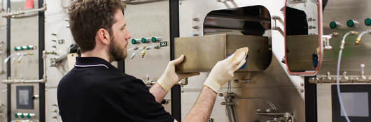 Guy inserting a drawer in chem lab