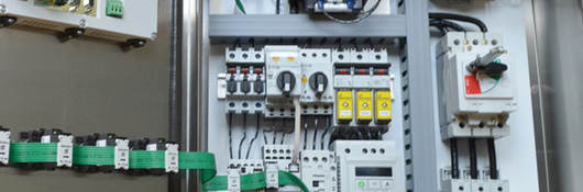 An opened industrial control panel showing components
