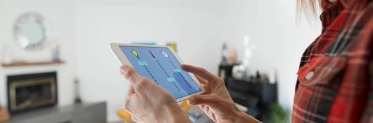 A woman using a table to connect to a smart house