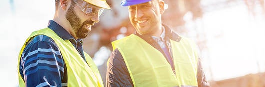 Two engineers smiling during inspection